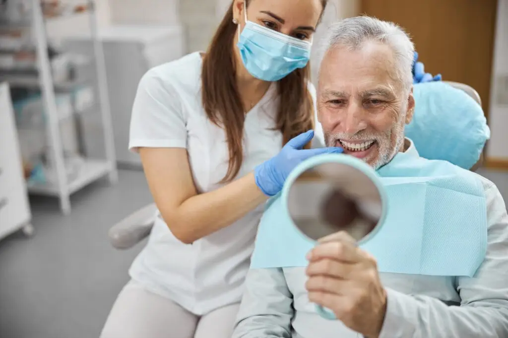 Aging gentleman being happy with his new dental implant
